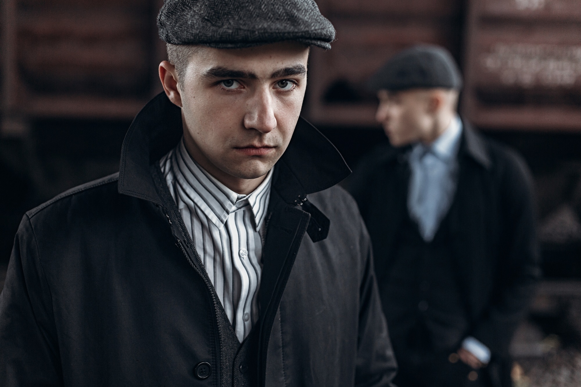 Stylish gangsters men, posing on background of railway